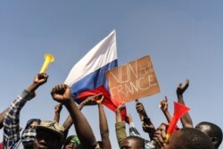 FILE - People gather in support of a coup that ousted President Roch Kabore, dissolved government, suspended the constitution and closed borders in Burkina Faso, Ouagadougou, Jan. 25, 2022.