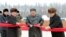 Pemimpin Korea Utara Kim Jong Un didampingi oleh Pak Pong Ju, wakil ketua Komisi Urusan Negara DPRK, memotong pita saat upacara di kotapraja Kabupaten Samjiyon, Korea Utara. (Foto: KCNA via REUTERS)
