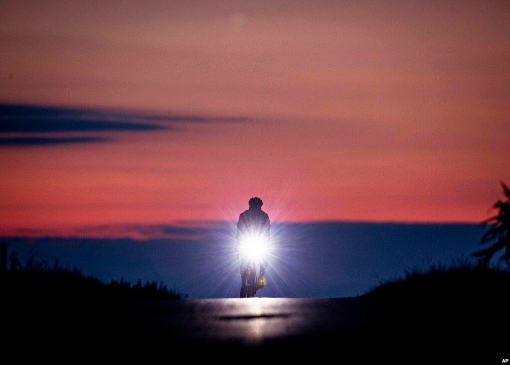 A man rides his bike to work before sunrise near Frankfurt, Germany.