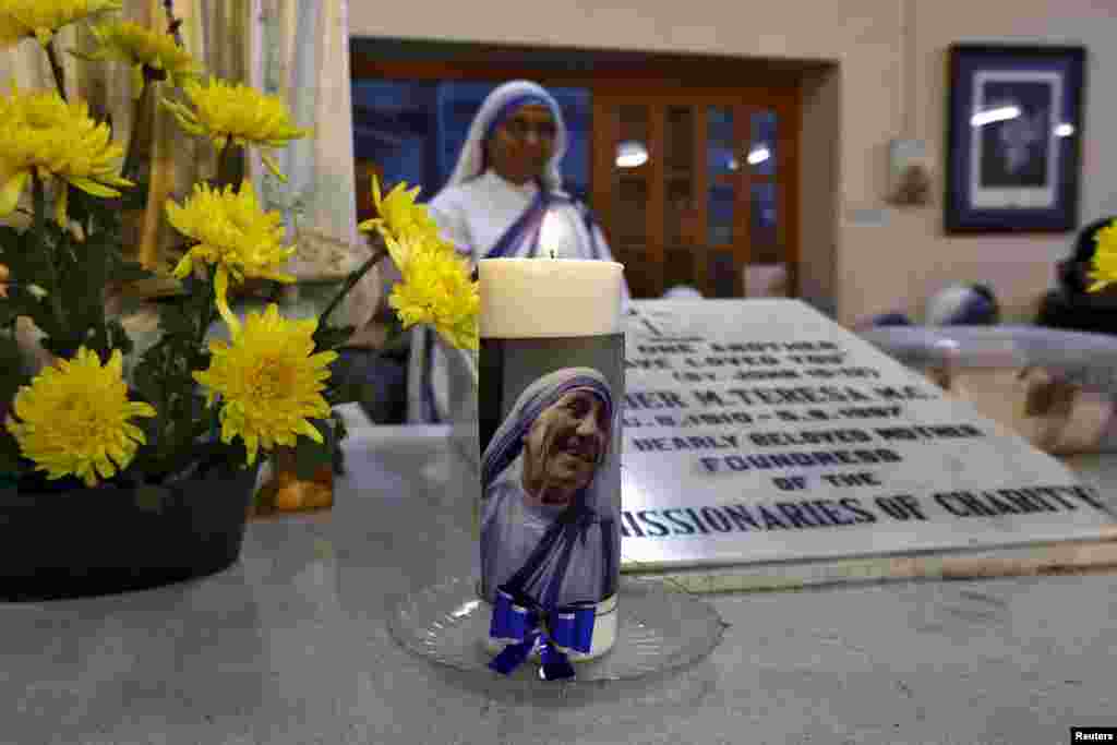 An image of Mother Teresa is seen on a candle used on Teresa&#39;s tomb during a special mass service in Kolkata, India. On Friday Pope Francis recognized a second miracle attributed to the late nun, clearing the way for her elevation to sainthood.