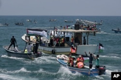 Two Palestinian fishing boats sail carrying 20 people including medical patients and students unable to leave through overland crossings, in Gaza City, May 29, 2018.