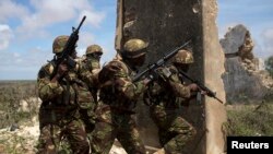 Kenya Defence Forces Rangers, who are part of the African Mission in Somalia (AMISOM), secure an area during a foot patrol on the outskirts of the controlled area of the old airport in the coastal town of Kismayu in southern Somalia, Nov. 12, 2013.