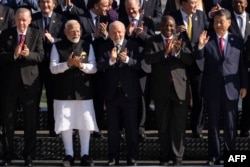 From left, Turkish President Recep Tayyip Erdogan, Indian Prime Minister Narendra Modi, Brazilian President Luiz Inacio Lula da Silva, South African President Cyril Ramaphosa and Chinese President Xi Jinping join G20 leaders for a photo in Rio de Janeiro, Brazil, Nov. 18, 2024.