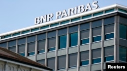FILE - A BNP Paribas sign is pictured on a building of the bank in Geneva, July 1, 2014. 