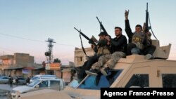 Members of the Syrian Democratic Forces deploy outside Ghwayran prison, also known as al-Sina'a, in Syria's northeastern city of Hasakah, Jan. 26, 2022, after retaking control of the facility from Islamic State group forces.