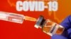 "COVID 19 ကာကွယ်ဆေး" လို့ တံဆိပ်တပ်ထားတဲ့ ဆေးပုလင်းတပုလင်း။ (ဧပြီ ၁၀၊ ၂၀၂၀)