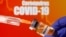 FILE PHOTO: A small bottle labeled with a "Vaccine" sticker is held near a medical syringe in front of displayed "Coronavirus COVID-19" words in this illustration taken April 10, 2020.