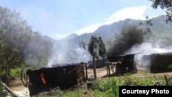 Smoke rises from homes in the village of Chukudum after a rampage by soldiers on Tuesday, Oct. 7, 2014, claimed at least three lives.