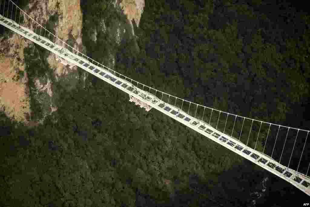 The world&#39;s highest and longest glass-bottomed bridge is seen above a valley in Zhangjiajie in China&#39;s Hunan Province.