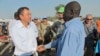 The U.N.'s top humanitarian official in South Sudan, Toby Lanzer (L), who was expelled from the country, visits displaced persons at a U.N. compound in 2013.