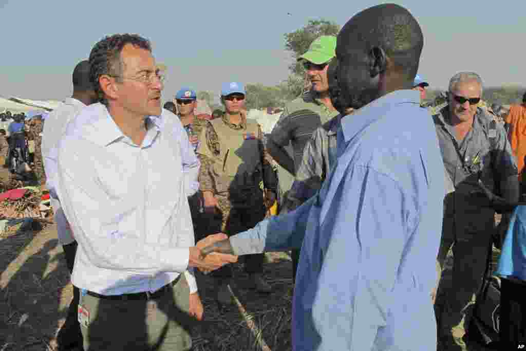 U.N.'s top humanitarian official in the country Toby Lanzer, left, makes a visit to assess the humanitarian situation at the U.N. compound where many displaced have sought shelter in Bentiu, in oil-rich Unity state, in South Sudan, Dec. 24, 2013. 