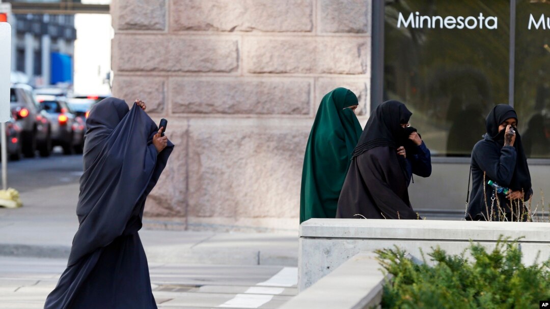FILE - Female members of Minnesota's Somali community cover their faces as they arrive April 23, 2015, for a detention hearing in federal court in St. Paul in the case of Minnesotans accused of plotting to travel to Syria to join the Islamic State group.