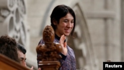 Nadia Murad Basee Taha, U.N. Goodwill Ambassador for the Dignity of Survivors of Human Trafficking, waves while being recognized by the speaker in the House of Commons on Parliament Hill in Ottawa, Ontario, Oct. 25, 2016.