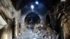 A citizen journalism image provided by Aleppo Media Center AMC which has been authenticated based on contents and AP reporting, shows Syrian rebels standing in the middle of a medieval market in Old Aleppo, which has been destroyed by fighting.