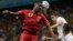 Belgium's Divock Origi heads the ball over United States' Matt Besler and Geoff Cameron, right, during the World Cup round of 16 soccer match between Belgium and the USA at the Arena Fonte Nova in Salvador, Brazil, July 1, 2014. 