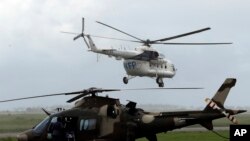 FILE - A World Food Programme (WFP) helicopter takes off, in Beira, Mozambique, March 22, 2019. 