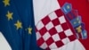 A Croatian, right, and a EU flag fly in downtown in Zagreb, Croatia, Jun. 30, 2013.