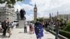 A demonstrator wrapped in the EU flag takes part in a protest opposing Britain's exit from the European Union in Parliament Square following yesterday's EU referendum result, London, Saturday, June 25, 2016.