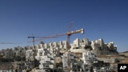 Houses under construction are seen in a Jewish settlement near Jerusalem known to Israelis as Har Homa and to Palestinians as Jabal Abu Ghneim, 08 Dec 2010