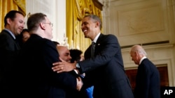 President Barack Obama greets supporters of immigration reform after speech in the East Room of the White House, Washington, Oct. 24, 2013.