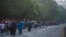 Migrants walk along the highway from Huehuetan to Huixtla in Chiapas state, Mexico, Nov. 19, 2021, on the second day of their journey from Tapachula, toward the northern states of Mexico and the US border. 