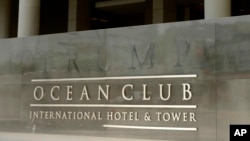 FILE - The marking of letters that formerly spelled T-R-U-M-P are part of the marquee outside the former Trump Ocean Club International Hotel and Tower in Panama City, April 9, 2018. 