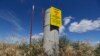 FILE - In this July 11, 2016 file photo, a sign warns of radioactive material stored underground on the Hanford Nuclear Reservation near Richland, Washington. 