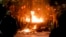 Protesters warm up next to a burning kiosk after minor clashes erupted during a protest in Bucharest, Romania, Feb. 2, 2017.