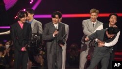 BTS accepts the award for artist of the year at the American Music Awards on Sunday, Nov. 21, 2021 at Microsoft Theater in Los Angeles. (AP Photo/Chris Pizzello)