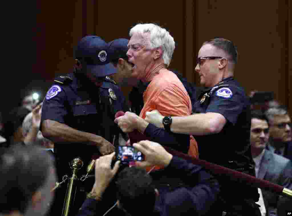 A protestor is removed from the Senate Intelligence Committee hearing room before the start of the confirmation hearing for CIA nominee Gina Haspel, on Capitol Hill in Washington.