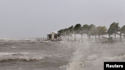 A house is seen as strong waves caused by Cyclone Evan wash a beach in Queen Elizabeth Drive, in Suva, Fiji, in this picture taken Dec.17, 2012. 