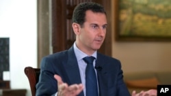 In this Sept. 21, 2016, photo released by the Syrian Presidency, Syrian President Bashar al-Assad speaks to The Associated Press at the presidential palace in Damascus, Syria.