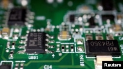 FILE - Semiconductor chips are seen on a printed circuit board in this illustration picture taken February 17, 2023. (REUTERS/Florence Lo/Illustration//File Photo)