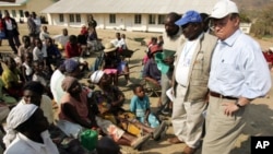 FILE: Then-US Ambassador to the UN food agency Tony Hall speaks to Zimbabwean villagers waiting to collect food aid near Mutare, Zimbabwe in this file photo. 