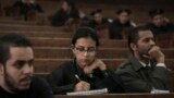 FILE - Mahinour el-Masry, an Egyptian activist, takes notes during a trial session of activists facing charges on organizing unauthorized protests, at a courtroom in Cairo, Egypt, Dec. 4, 2014..