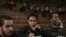 FILE - Mahinour el-Masry, an Egyptian activist, takes notes during a trial session of activists facing charges on organizing unauthorized protests, at a courtroom in Cairo, Egypt, Dec. 4, 2014.