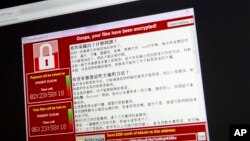 Screenshot of the warning screen from a purported ransomware attack, as captured by a computer user in Taiwan, is seen on laptop in Beijing, May 13, 2017. 