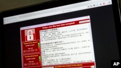 Screenshot of the warning screen from a purported ransomware attack, as captured by a computer user in Taiwan, is seen on laptop in Beijing, May 13, 2017. 