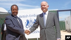British Foreign Secretary William Hague, right, shakes hands with Somali President, Hassan Sheikh Mohamud, at the opening of the newly built British Embassy in the Somali capital Mogadishu, Apr. 25, 2013.