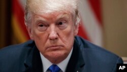 In this Feb. 28, 2018 photo, President Donald Trump pauses during a meeting in the Cabinet Room of the White House, in Washington.