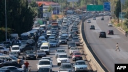 Vehicles wait in traffic in the town of Damour, south of the capital Beirut, as people flee southern Lebanon, Sept. 24, 2024.