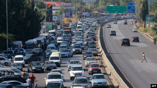 Vehicles wait in traffic in the town of Damour, south of the capital Beirut, as people flee southern Lebanon, Sept. 24, 2024.