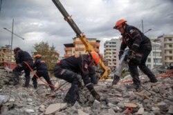 Turkish rescuers search at a collapsed building in Durres, western Albania, Nov. 28, 2019.