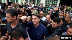 Jair Bolsonaro, far-right lawmaker and presidential candidate of the Social Liberal Party, gestures after casting his vote, in Rio de Janeiro, Brazil, Oct. 7, 2018. 