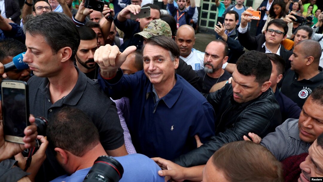 Jair Bolsonaro, far-right lawmaker and presidential candidate of the Social Liberal Party (PSL), gestures after casting his vote, in Rio de Janeiro, Brazil, Oct. 7, 2018. 