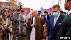 FILE - Afghanistan's President Ashraf Ghani visits an exhibition during celebrations to mark Afghan New Year (Newroz), in Kabul, Afghanistan, March 21, 2021.