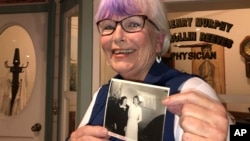 Nurse practitioner Sigrid Stokes, 76, holds a photograph of her mother talking to Shirley Temple, at the Salinas Valley Memorial Hospital in Salinas, Calif., Wednesday, Feb. 3, 2021. (AP Photo/Haven Daley)