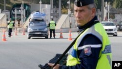 French police check vehicles at the France Italy border in La Turbie, southeastern France, Nov. 14, 2015. 