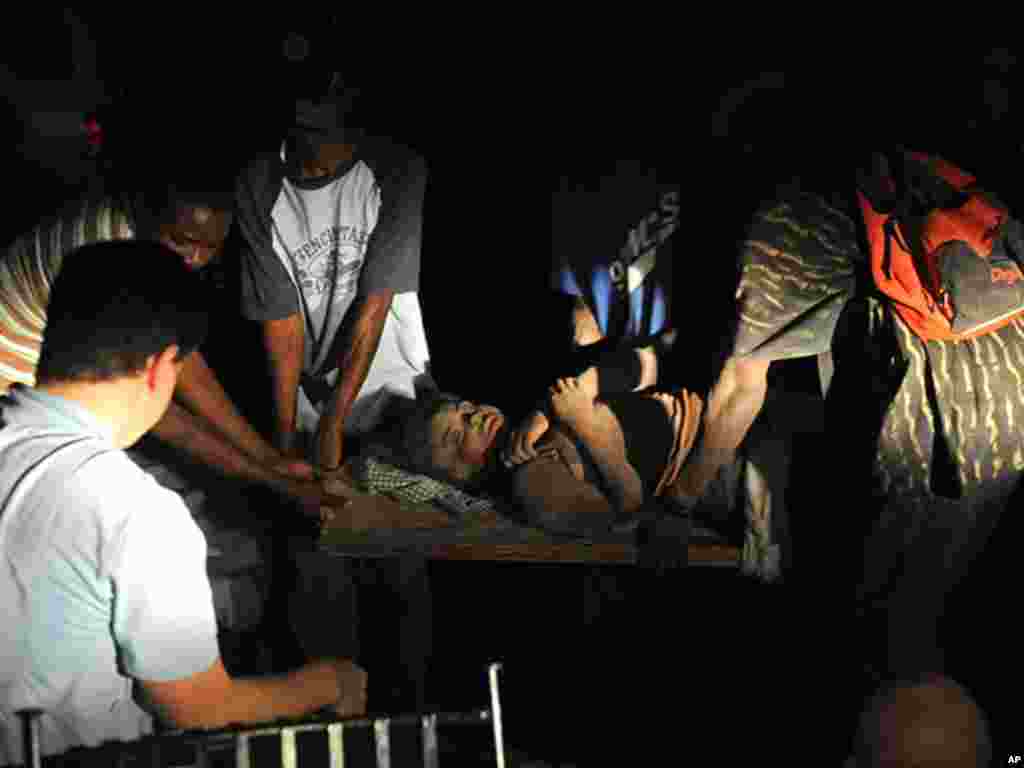 People carry an injured person after an earthquake in Port-au-Prince, Haiti, late Tuesday, Jan. 12, 2010. A 7.0-magnitude earthquake, the largest ever recorded in the area, rocked Haiti on Tuesday. (AP Photo/Jorge Cruz) ** NO PUBLICAR EN REPUBLICA DOMIN