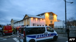 Kendaraan damkar dan polisi terparkir dekat lokasi penikaman di mana seorang pria diduga membunuh satu orang dan melukai dua polisi di Kota Mulhouse, bagian timur Prancis, Sabtu, 22 Februari 2025. (Foto: Sebastien Bozon/AFP)